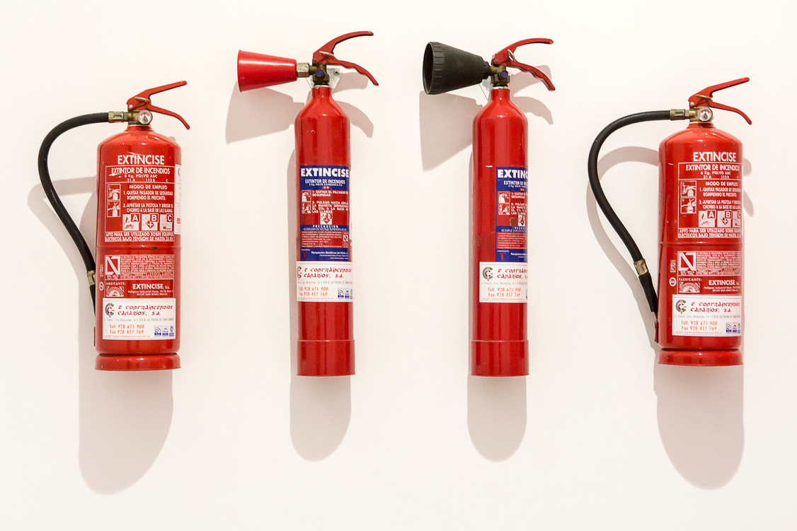 Assorted Fire Extinguishers on White Surface